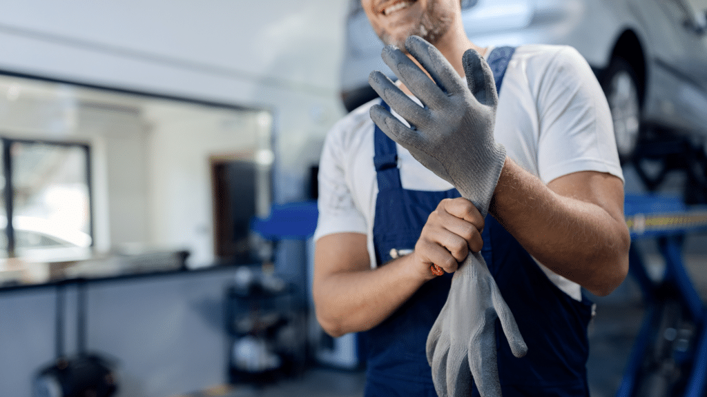unrecognizable-mechanic-using-working-gloves-auto-repair