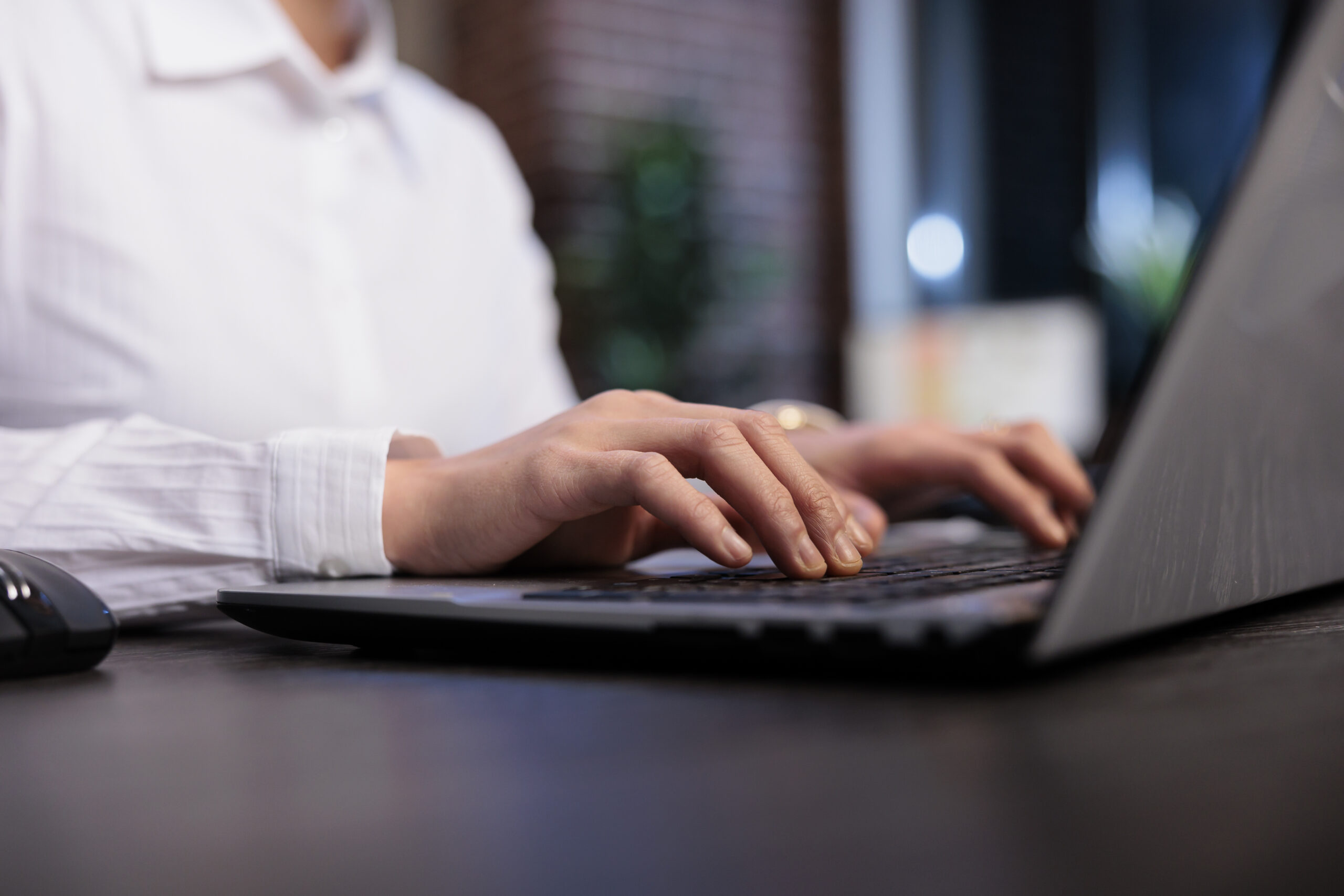 Close up of financial advisor sitting at desk in office workspace